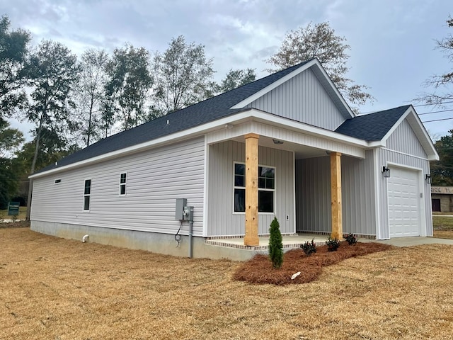 view of home's exterior featuring a porch and a garage