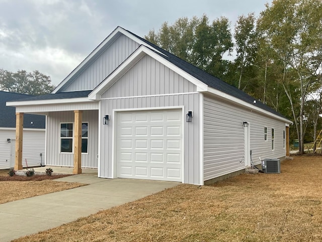 view of front of house with a garage and central air condition unit