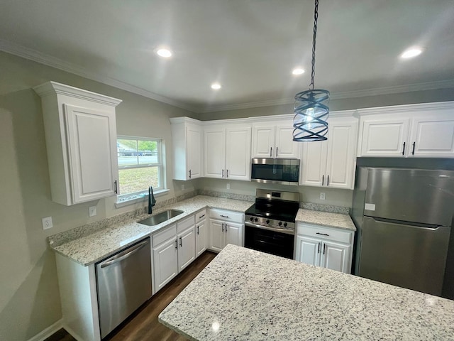 kitchen featuring sink, white cabinetry, stainless steel appliances, and hanging light fixtures