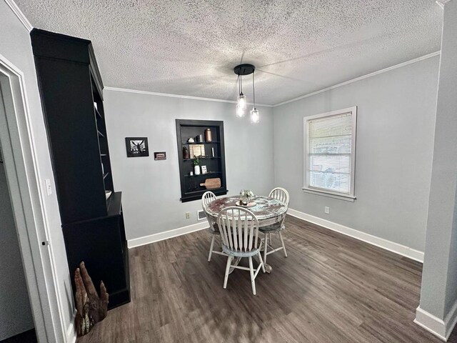 305 Highland Ave, Ozark, AL 36360 - dining area with dark wood-style floors, ornamental molding, a textured ceiling, built in features, and baseboards