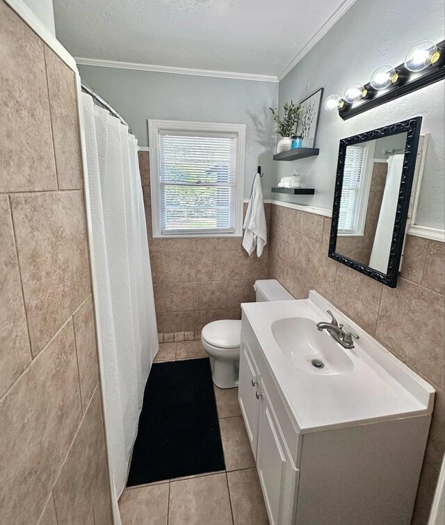 305 Highland Ave, Ozark, AL 36360 - bathroom featuring tile walls, tile patterned floors, ornamental molding, toilet, and vanity