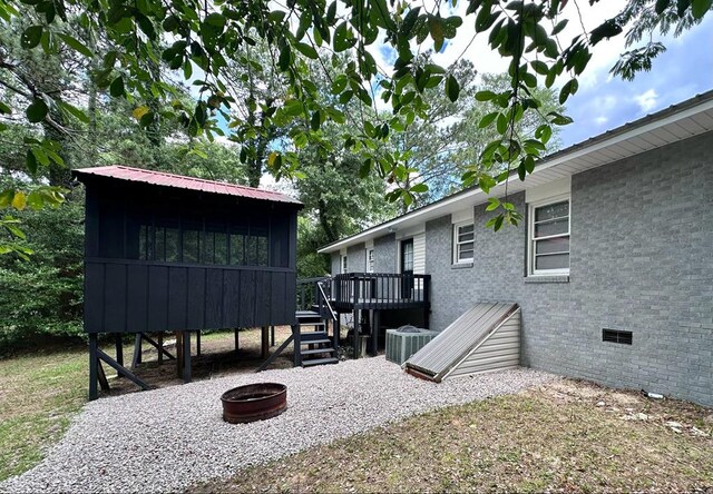 305 Highland Ave, Ozark, AL 36360 - view of patio with a wooden deck, an outdoor fire pit, and central air condition unit