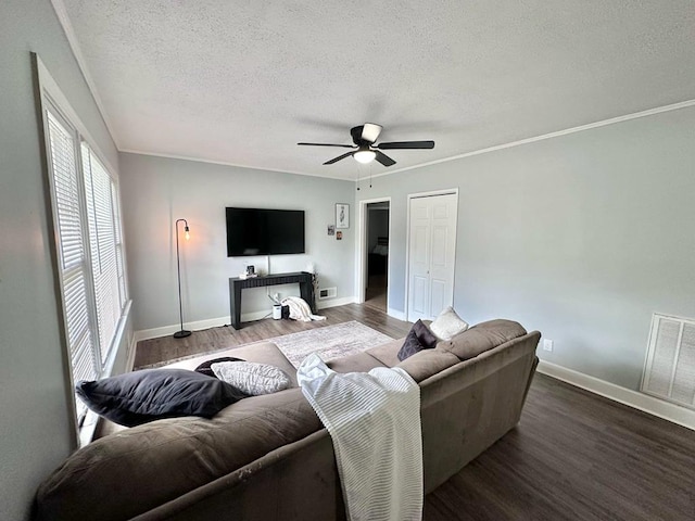 305 Highland Ave, Ozark, AL 36360 - living room featuring ceiling fan, a textured ceiling, wood finished floors, baseboards, and crown molding