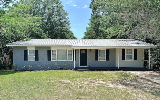 305 Highland Ave, Ozark, AL 36360 - single story home featuring a front lawn, metal roof, a porch, driveway, and an attached carport