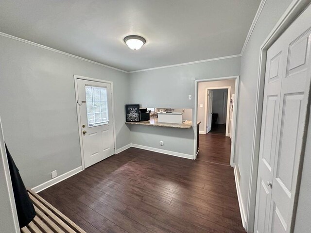 305 Highland Ave, Ozark, AL 36360 - foyer with ornamental molding, dark wood-type flooring, and baseboards