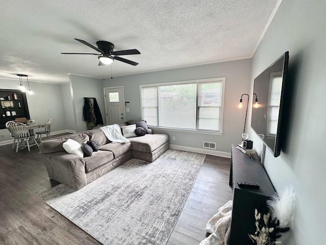 305 Highland Ave, Ozark, AL 36360 - living area with a ceiling fan, a textured ceiling, wood finished floors, and baseboards