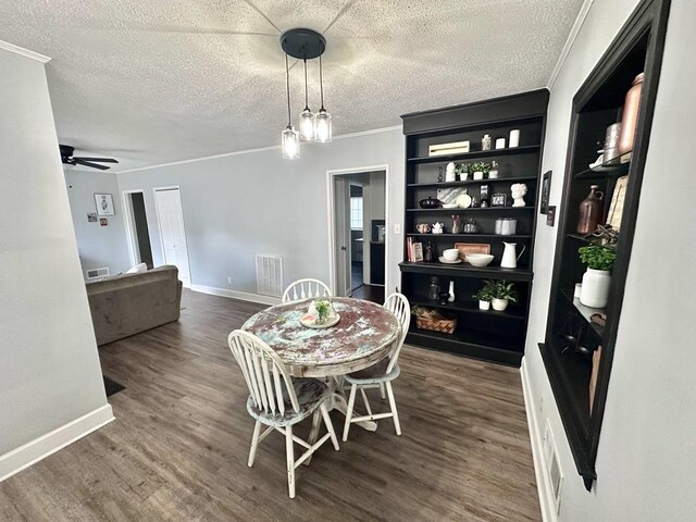 305 Highland Ave, Ozark, AL 36360 - dining area featuring wood finished floors, ornamental molding, a textured ceiling, and baseboards