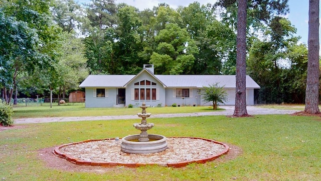 391 Hatton Rd, Dothan, AL 36301 - view of front facade with a chimney, a metal roof, a garage, and driveway