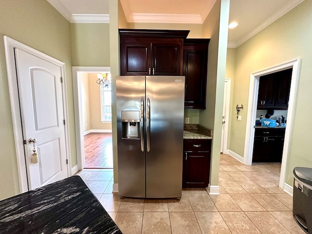 kitchen featuring stainless steel refrigerator with ice dispenser, ornamental molding, light tile patterned flooring, and dark brown cabinets