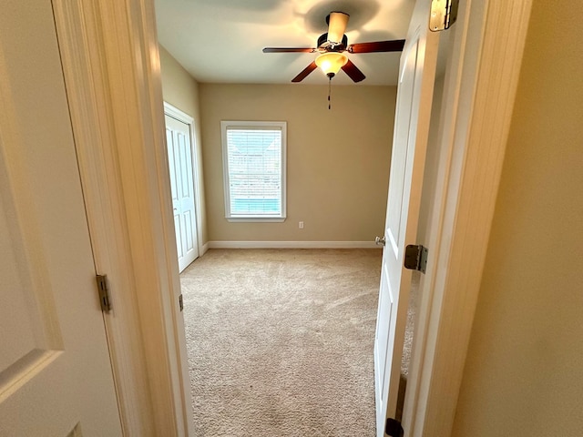 unfurnished bedroom with light carpet and ceiling fan