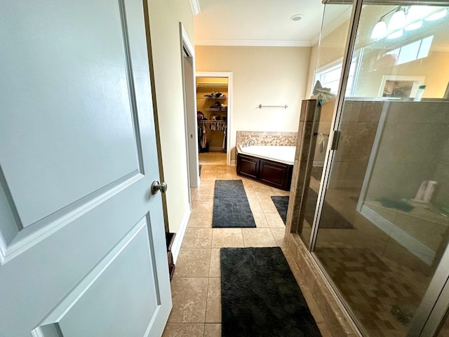 202 Frisco Ln, Enterprise, AL 36330 - bathroom featuring a garden tub, ornamental molding, a walk in closet, tile patterned floors, and a stall shower