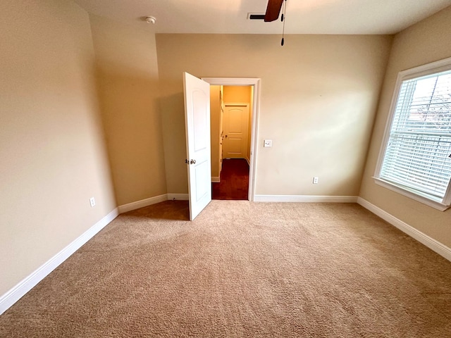 202 Frisco Ln, Enterprise, AL 36330 - spare room featuring baseboards, ceiling fan, and light carpet