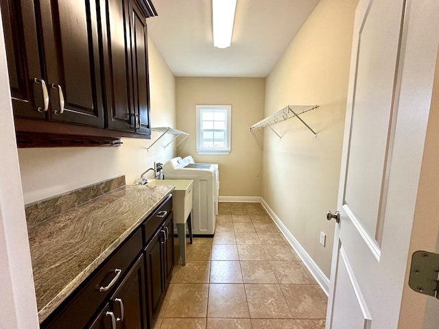 202 Frisco Ln, Enterprise, AL 36330 - clothes washing area featuring washing machine and clothes dryer, cabinet space, a sink, baseboards, and light tile patterned floors
