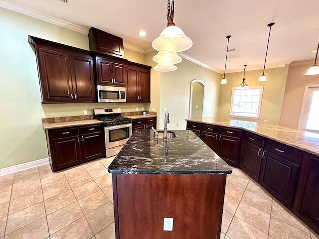 202 Frisco Ln, Enterprise, AL 36330 - kitchen with a kitchen island with sink, crown molding, arched walkways, stainless steel appliances, and light tile patterned flooring