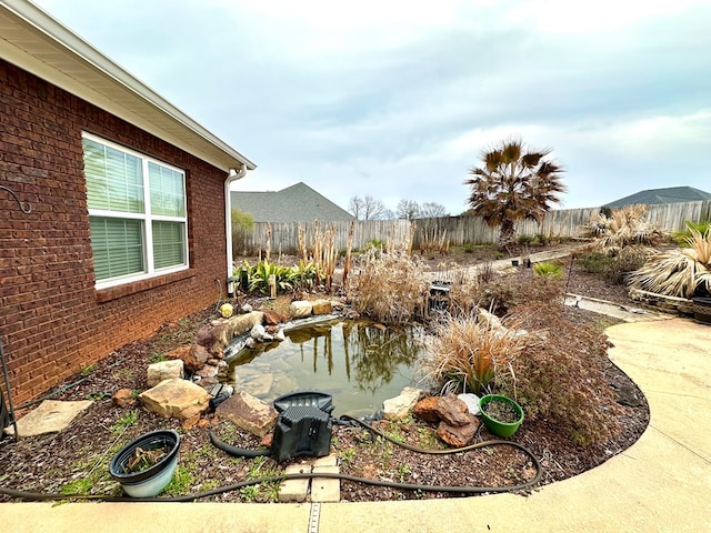 202 Frisco Ln, Enterprise, AL 36330 - view of yard with a fenced backyard and a small pond