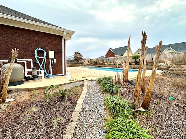 view of yard with a fenced in pool and a patio area