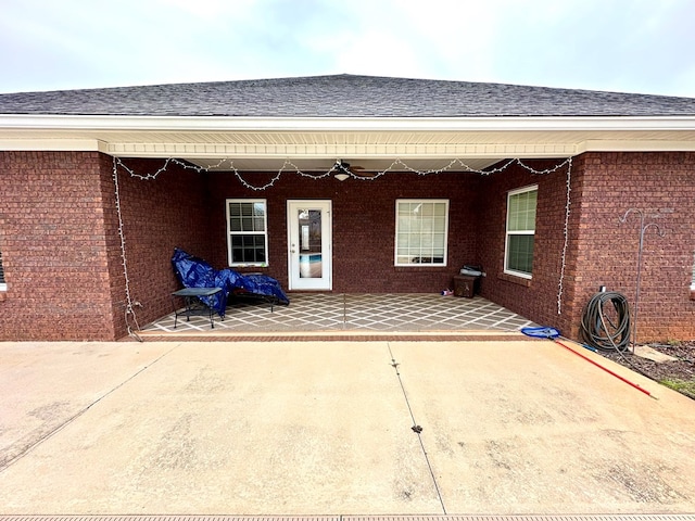 202 Frisco Ln, Enterprise, AL 36330 - property entrance with brick siding, a patio, and roof with shingles