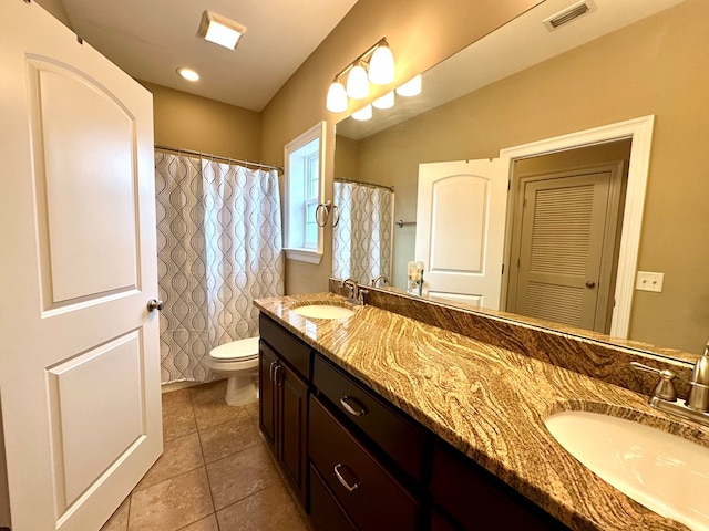 202 Frisco Ln, Enterprise, AL 36330 - full bath with visible vents, a sink, tile patterned flooring, and toilet
