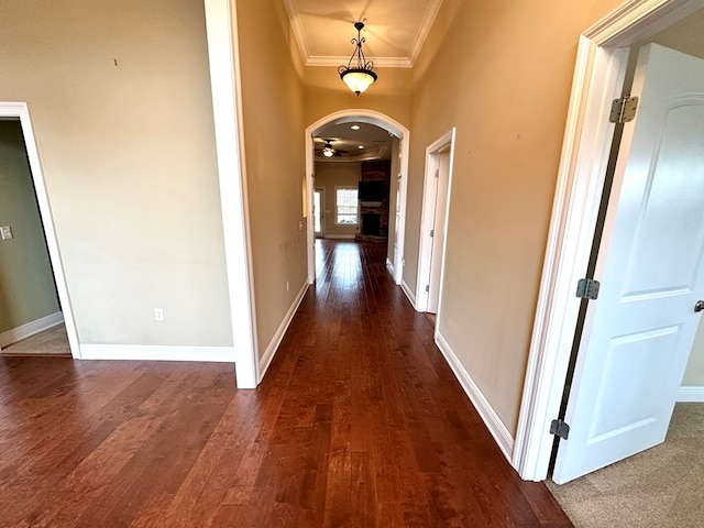 202 Frisco Ln, Enterprise, AL 36330 - hall with crown molding, arched walkways, baseboards, and dark wood-style floors