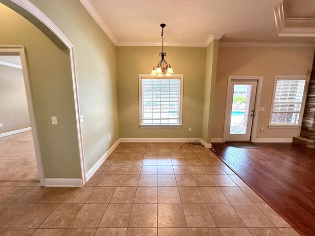 kitchen featuring a spacious island, crown molding, decorative light fixtures, dark brown cabinets, and appliances with stainless steel finishes