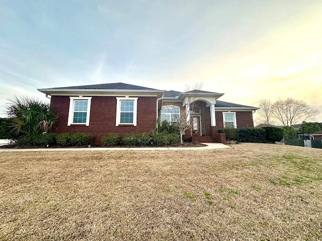 ranch-style home with a lawn