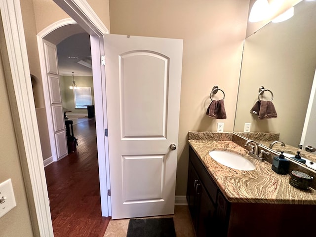 202 Frisco Ln, Enterprise, AL 36330 - bathroom featuring vanity, baseboards, and wood finished floors