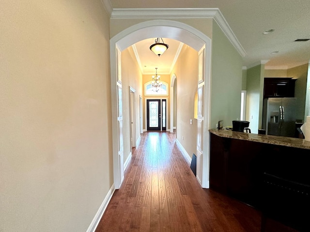 202 Frisco Ln, Enterprise, AL 36330 - hallway with an inviting chandelier, ornamental molding, baseboards, dark wood-style floors, and arched walkways