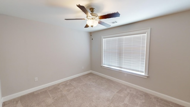 unfurnished room featuring ceiling fan and light carpet