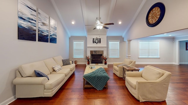 living room featuring dark hardwood / wood-style flooring, crown molding, and a tile fireplace