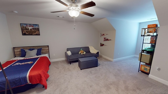 carpeted bedroom with ceiling fan and vaulted ceiling