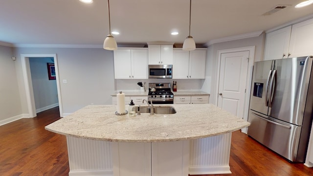 kitchen featuring a kitchen island with sink, white cabinets, and appliances with stainless steel finishes