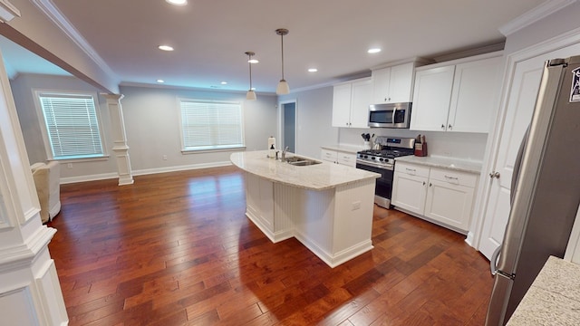 kitchen with dark wood-type flooring, decorative light fixtures, a center island with sink, white cabinets, and appliances with stainless steel finishes