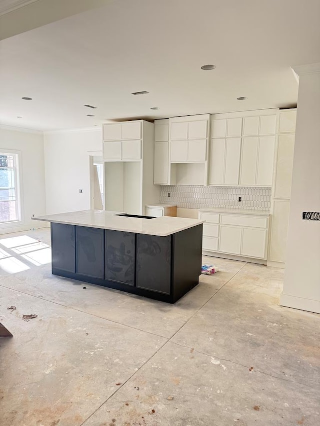 kitchen with white cabinetry, a large island, and tasteful backsplash