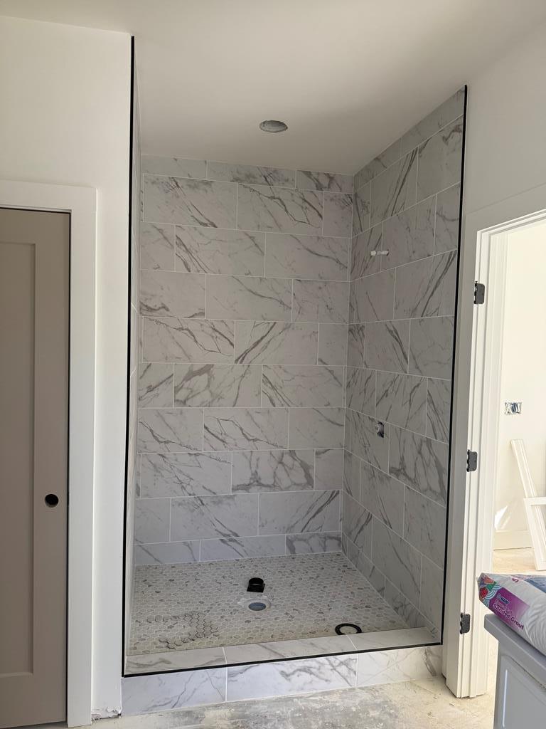 bathroom featuring a stall shower and marble finish floor