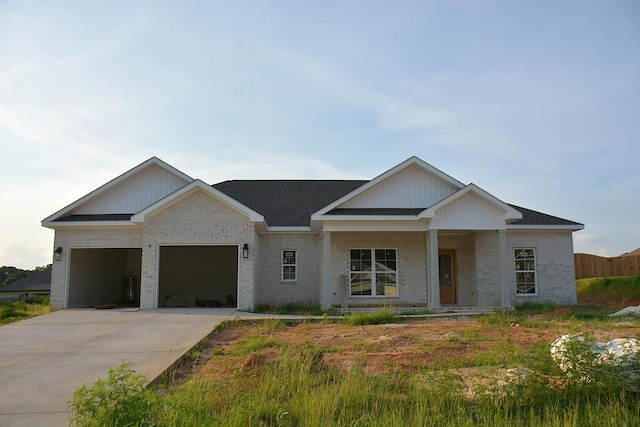 110 Mikala Ct, Enterprise, AL 36330 - view of front of house with brick siding, an attached garage, concrete driveway, covered porch, and a shingled roof
