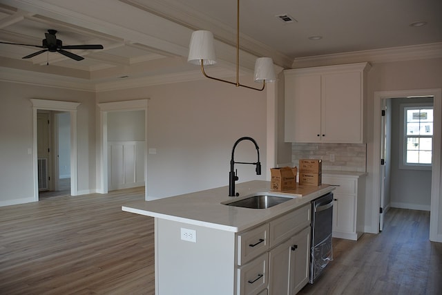 110 Mikala Ct, Enterprise, AL 36330 - kitchen with ornamental molding, white cabinetry, stainless steel dishwasher, light wood-style flooring, and light countertops