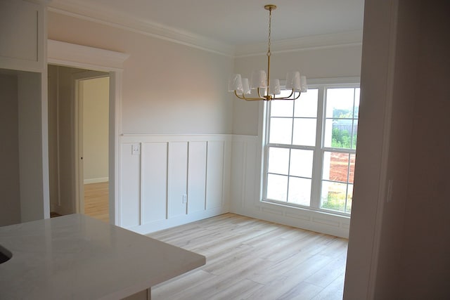 110 Mikala Ct, Enterprise, AL 36330 - unfurnished dining area with a chandelier, light wood finished floors, ornamental molding, and a wainscoted wall