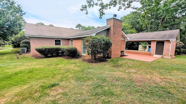 5 Walford Pl, Dothan, AL 36301 - back of house with a patio area, a chimney, a carport, and brick siding