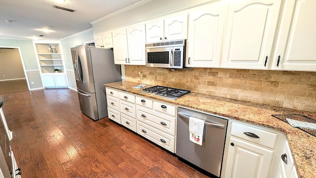 5 Walford Pl, Dothan, AL 36301 - kitchen featuring appliances with stainless steel finishes, crown molding, light stone countertops, built in shelves, and backsplash