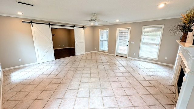 5 Walford Pl, Dothan, AL 36301 - spare room with a barn door, a fireplace, crown molding, ceiling fan, and healthy amount of natural light