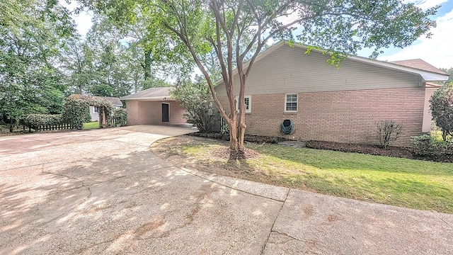 5 Walford Pl, Dothan, AL 36301 - view of side of property with driveway, a yard, brick siding, and a carport