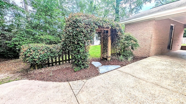 5 Walford Pl, Dothan, AL 36301 - view of side of home with brick siding, a patio area, and concrete driveway