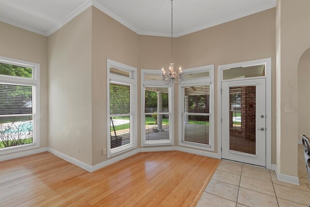 707 Edinburgh Way, Dothan, AL 36305 - unfurnished dining area featuring crown molding, baseboards, light wood-style flooring, and a chandelier
