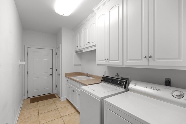 707 Edinburgh Way, Dothan, AL 36305 - washroom featuring cabinet space, washing machine and clothes dryer, a sink, baseboards, and light tile patterned floors