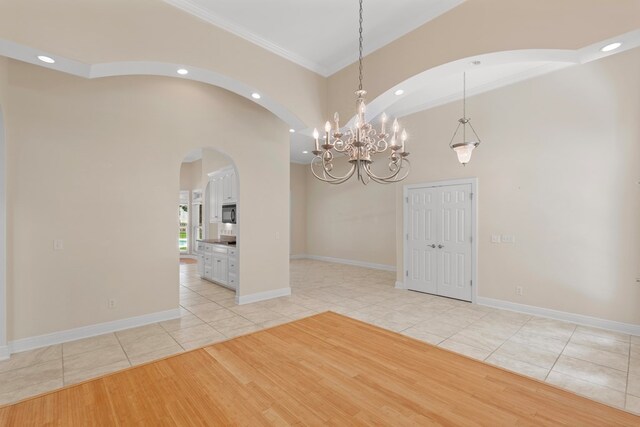 707 Edinburgh Way, Dothan, AL 36305 - unfurnished dining area featuring crown molding, arched walkways, light tile patterned floors, and recessed lighting