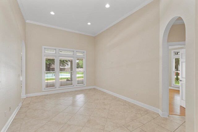 707 Edinburgh Way, Dothan, AL 36305 - unfurnished room with arched walkways, light tile patterned floors, plenty of natural light, and ornamental molding