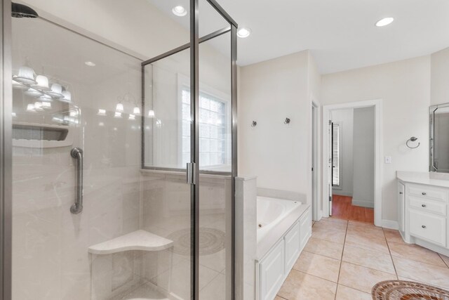 707 Edinburgh Way, Dothan, AL 36305 - bathroom with vanity, tile patterned flooring, a garden tub, and a stall shower