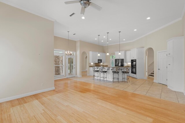 707 Edinburgh Way, Dothan, AL 36305 - kitchen featuring a breakfast bar area, arched walkways, and crown molding
