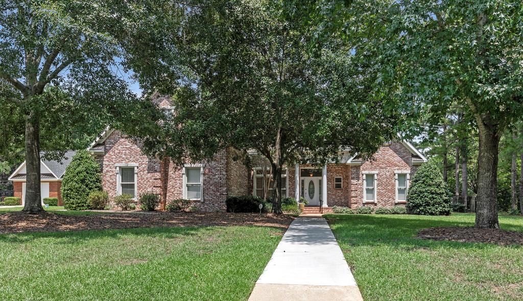 obstructed view of property featuring a front yard