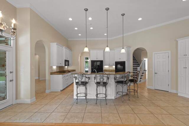 707 Edinburgh Way, Dothan, AL 36305 - kitchen with arched walkways, black appliances, light tile patterned flooring, and white cabinetry